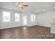 Living room featuring hardwood floors, neutral walls, plenty of natural light, and modern fixtures at 3916 Well Fleet Dr, Fuquay Varina, NC 27526