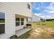 View of covered patio, backyard, and nearby home at 4097 Cordiality Church Rd, Nashville, NC 27856