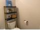A compact bathroom with a toilet and a decorative shelf at 4097 Cordiality Church Rd, Nashville, NC 27856