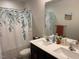Well-appointed bathroom featuring a dual sink vanity and decorative shower curtain at 4097 Cordiality Church Rd, Nashville, NC 27856