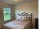 Cozy bedroom with a decorative headboard and a view of the outdoors at 4097 Cordiality Church Rd, Nashville, NC 27856