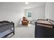 Cozy bedroom with a comfortable recliner and two bassinets, creating a nurturing space at 4097 Cordiality Church Rd, Nashville, NC 27856