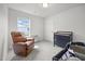 Cozy bedroom with a comfortable recliner, changing table, and a neutral color scheme at 4097 Cordiality Church Rd, Nashville, NC 27856