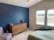 Stylish bedroom featuring a trendy blue accent wall and soft, neutral carpet at 4097 Cordiality Church Rd, Nashville, NC 27856