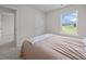 Bright bedroom features neutral walls, plush carpet, and a scenic view from the window at 4097 Cordiality Church Rd, Nashville, NC 27856