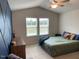 Bright bedroom with a modern accent wall and a ceiling fan for added comfort at 4097 Cordiality Church Rd, Nashville, NC 27856