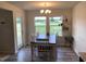 Light-filled dining room featuring a chandelier and views of the backyard at 4097 Cordiality Church Rd, Nashville, NC 27856