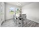 Bright dining room features a modern chandelier and large windows offering scenic outdoor views at 4097 Cordiality Church Rd, Nashville, NC 27856
