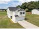 Aerial view of a two-story home with a two-car garage and well-maintained lawn and landscaping at 4097 Cordiality Church Rd, Nashville, NC 27856