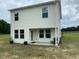 Two-story home with vinyl siding and a simple patio at 4097 Cordiality Church Rd, Nashville, NC 27856