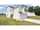 Side view of home with a two-car garage and well-maintained lawn and landscaping at 4097 Cordiality Church Rd, Nashville, NC 27856