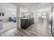 Well-lit kitchen with a functional island, wood floors, and an open view into the living room at 4097 Cordiality Church Rd, Nashville, NC 27856