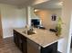 Kitchen island with granite countertop and sink with adjacent living area at 4097 Cordiality Church Rd, Nashville, NC 27856