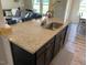 Kitchen island with granite countertops, dark wood cabinets, and stainless steel sink at 4097 Cordiality Church Rd, Nashville, NC 27856
