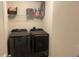 A functional laundry room featuring a modern washer and dryer set, with shelving at 4097 Cordiality Church Rd, Nashville, NC 27856