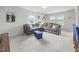 Bright living room features large windows, plush carpet, and a comfortable gray sectional at 4097 Cordiality Church Rd, Nashville, NC 27856
