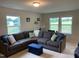 Cozy living room with a plush gray sectional sofa and bright, natural lighting at 4097 Cordiality Church Rd, Nashville, NC 27856