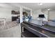 Open concept living room and kitchen area with piano, barstool seating and stainless appliances at 4097 Cordiality Church Rd, Nashville, NC 27856