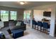 Open-concept living area with a comfortable gray sofa and a kitchen island with bar seating at 4097 Cordiality Church Rd, Nashville, NC 27856