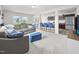 Spacious living room with gray sofa, plush carpet, and open to the kitchen at 4097 Cordiality Church Rd, Nashville, NC 27856