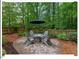 Backyard patio with stylish outdoor furniture and lush landscaping for relaxation and entertainment at 45 Birnham Ln, Durham, NC 27707