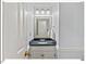Tastefully updated half-bathroom featuring a granite countertop and modern lighting at 45 Birnham Ln, Durham, NC 27707