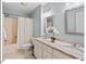 Traditional bathroom with granite countertops, double sinks, and a shower-tub combo, offering comfort and functionality at 45 Birnham Ln, Durham, NC 27707