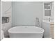 Modern bathroom with a luxurious soaking tub, perfect for relaxation, complemented by stylish fixtures and finishes at 45 Birnham Ln, Durham, NC 27707