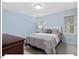 Inviting bedroom with soft blue walls, large windows, and a comfortable queen-size bed for relaxation at 45 Birnham Ln, Durham, NC 27707