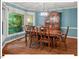 Elegant dining room with a large window, classic wood furniture, and modern lighting at 45 Birnham Ln, Durham, NC 27707