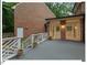 Back of house showcasing the outdoor deck, brick exterior, and well-maintained backyard at 45 Birnham Ln, Durham, NC 27707