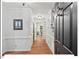 Bright and spacious hallway with hardwood floors and classic wainscoting detail at 45 Birnham Ln, Durham, NC 27707