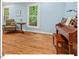 Bright living room with hardwood floors and natural light, showcasing a piano and comfortable chair at 45 Birnham Ln, Durham, NC 27707