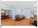 Inviting living room with access to dining area featuring hardwood floors and soft blue walls at 45 Birnham Ln, Durham, NC 27707