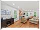 Spacious living room featuring a brick fireplace, hardwood floors, and comfortable seating at 45 Birnham Ln, Durham, NC 27707