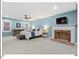 Large main bedroom with a fireplace, TV, a ceiling fan, and a light blue color palette at 45 Birnham Ln, Durham, NC 27707
