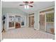 Bright sunroom featuring tile floors, ceiling fan, and glass doors to the living room and deck at 45 Birnham Ln, Durham, NC 27707