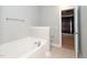 Clean bathroom featuring a soaking tub and tile flooring at 4807 Landover Charge Ln, Raleigh, NC 27616