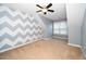 Attic bedroom with accent wall and carpeted floors at 4807 Landover Charge Ln, Raleigh, NC 27616