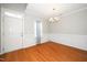 Elegant dining room with hardwood floors, wainscoting, and a stylish chandelier at 4807 Landover Charge Ln, Raleigh, NC 27616
