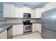 Well-maintained kitchen features stainless steel appliances, countertops, and ample cabinetry at 4807 Landover Charge Ln, Raleigh, NC 27616