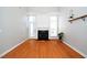 Comfortable living room with a fireplace, hardwood floors, and large windows at 4807 Landover Charge Ln, Raleigh, NC 27616