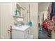 Cozy bathroom with a white vanity, cleaning supplies, and access to an adjacent bedroom at 501 Magnolia Dr, Rocky Mount, NC 27801