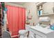 Modest bathroom featuring a toilet, sink, and shower with a red curtain at 501 Magnolia Dr, Rocky Mount, NC 27801