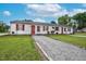 Exterior shot of a multi-unit home with red accents and gravel driveway at 501 Magnolia Dr, Rocky Mount, NC 27801