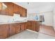 Kitchen featuring wood cabinets and an eat-in bar, adjacent to the living room at 501 Magnolia Dr, Rocky Mount, NC 27801