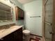 Bathroom featuring a sink, toilet, vanity mirror, and tile shower at 507 Holtz Ln, Cary, NC 27511