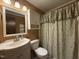 Cozy bathroom with decorative floral shower curtain, vanity and wall mirror at 507 Holtz Ln, Cary, NC 27511