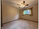 Neutral bedroom with plush carpeting, window views, and a ceiling fan at 507 Holtz Ln, Cary, NC 27511