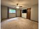 Cozy bedroom with neutral carpet, ceiling fan, window, and ample closet space at 507 Holtz Ln, Cary, NC 27511